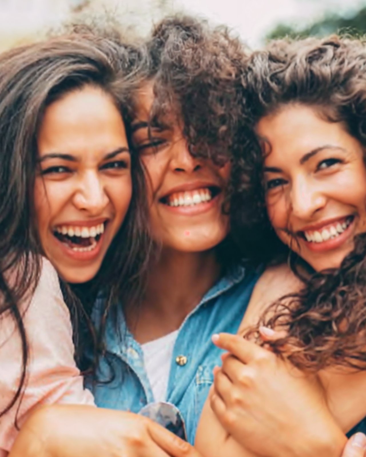 Three women laughing together