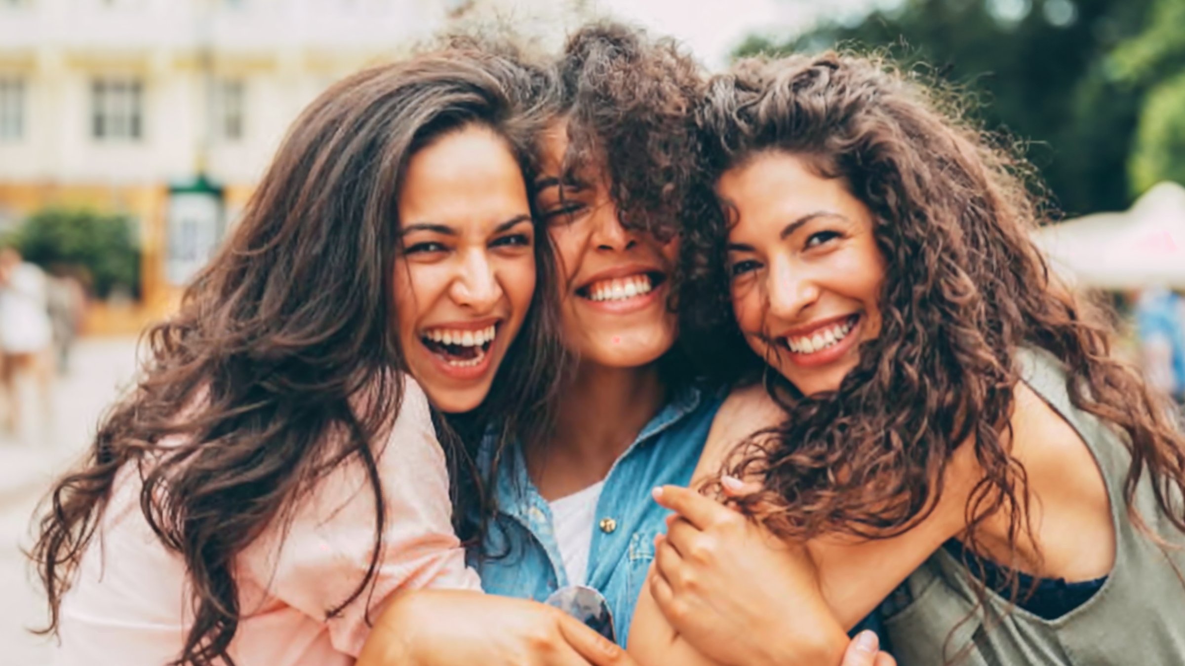 Three women laughing together